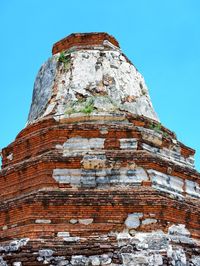 Low angle view of old ruins against blue sky