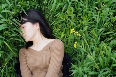 Woman sleeping on plants