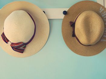 High angle view of hat hanging against white background