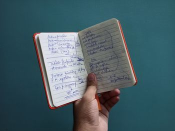 Low section of person holding book with text