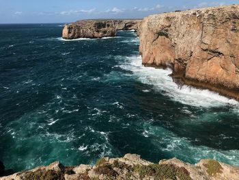 Scenic view of rock formation in sea against sky