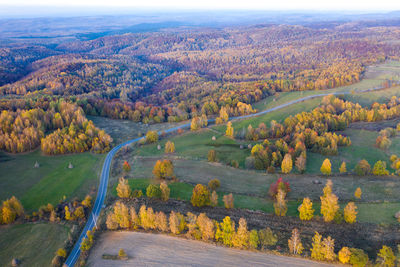 Aerial picture of a countryside village road, agricultural fields by drone. transylvania, romania