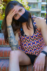 Portrait of young woman sitting outdoors