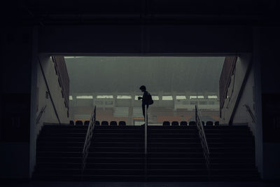 Rear view of silhouette people walking on staircase