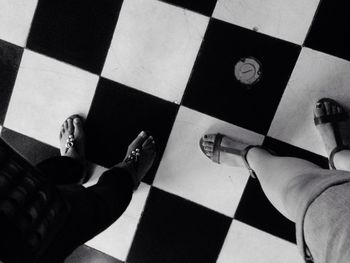 Close-up of woman standing on tiled floor