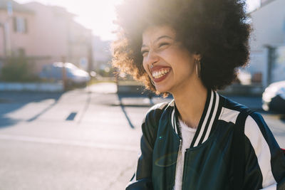 Portrait of smiling young woman standing outdoors