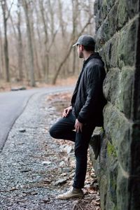 Full length side view of a man walking on tree trunk