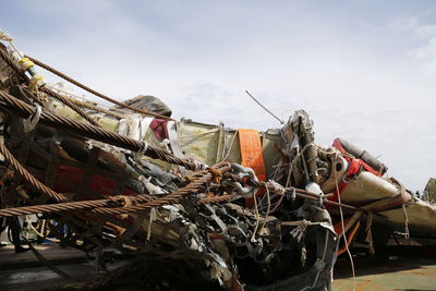 Airplane wreck on shore against sky