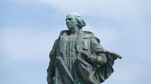 Low angle view of statue against sky