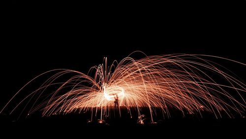Firework and sparkling steel wool display at night