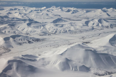 Aerial view of snow covered land