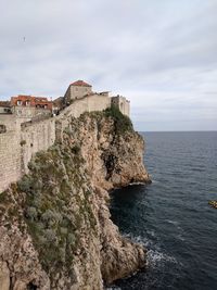 Historic building by sea against sky