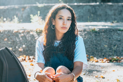 Portrait of young woman standing on field