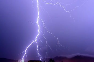 Low angle view of lightning against sky at night