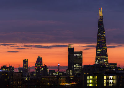 Illuminated city at sunset