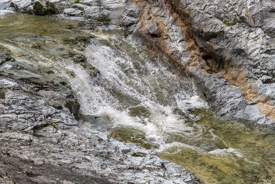 Full frame shot of stream flowing through rocks