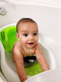 Portrait of cute baby boy in bathroom