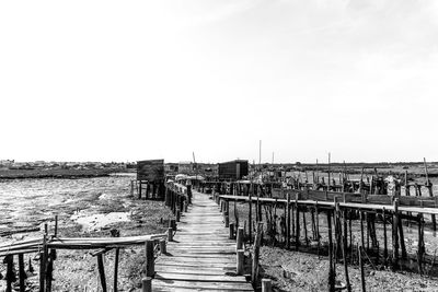 Pier over sea against clear sky