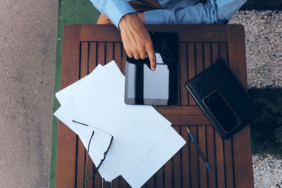 Low section of man sitting on table