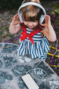 Cute girl listening music outdoors