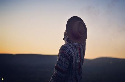 Rear view of man at beach against sky