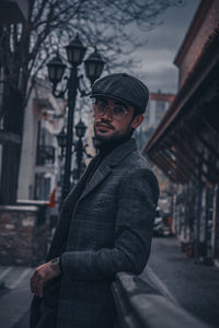 Young man standing on street in city