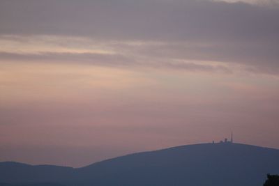 Scenic view of silhouette mountains against sky at sunset