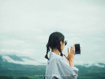 Rear view of man photographing