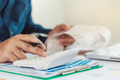 Midsection of woman working on table