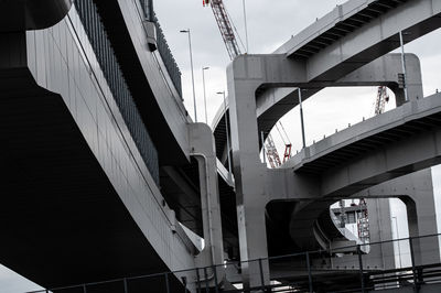 Low angle view of elevated walkway against buildings