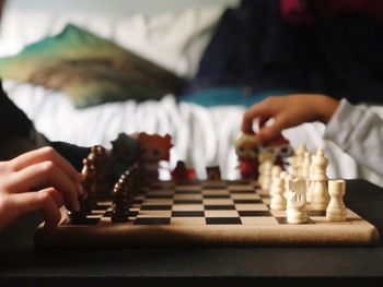 Cropped image of people playing chess