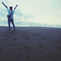 Rear view of person standing on beach