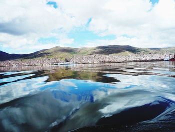 Scenic view of lake against cloudy sky