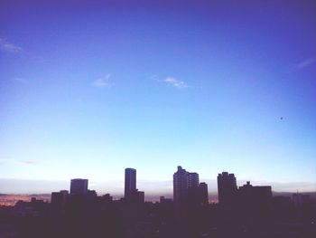 View of cityscape against blue sky