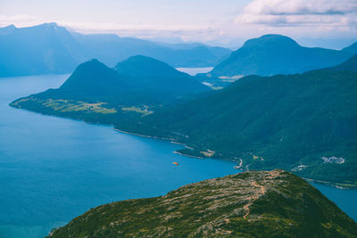 Aerial view of sea and mountains against sky