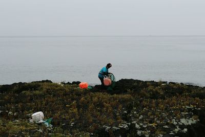 Woman on beach against clear sky