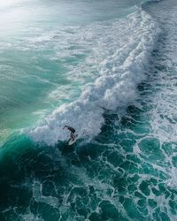 High angle view of man surfing in sea