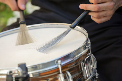 Close-up of man playing drum