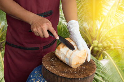 Man cutting coconut