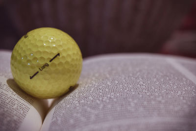 Close-up of yellow ball on table