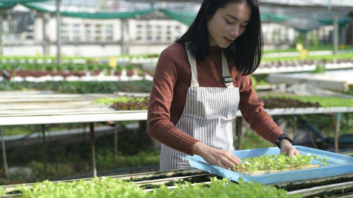 Full length of a young woman preparing food