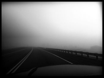 Road passing through foggy weather