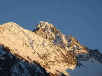 Scenic view of snowcapped mountains against clear sky