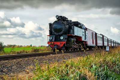 Train on railroad track against sky