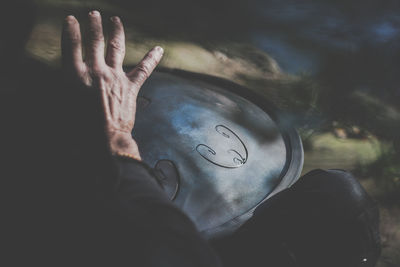 High angle view of person hand on glass