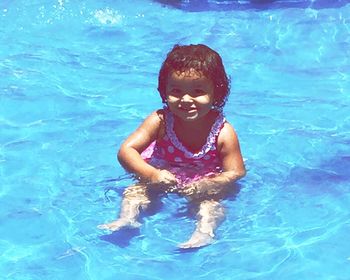 High angle portrait of woman swimming in pool