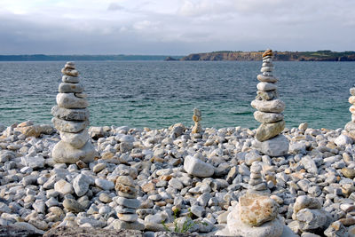 Rocks on beach against sky
