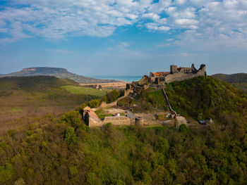 Aerial view about castle of szigliget with lake balaton at the background. spring landscape.