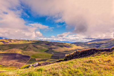 Scenic view of landscape against cloudy sky
