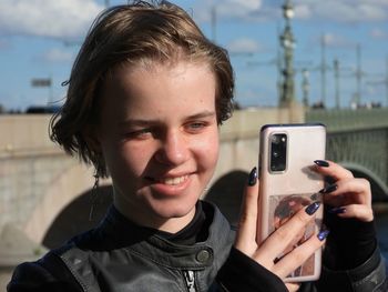 Young woman photographing with camera